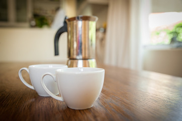 white cups and coffee plunger