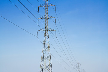High voltage electric pole with blue sky and engineering backgro