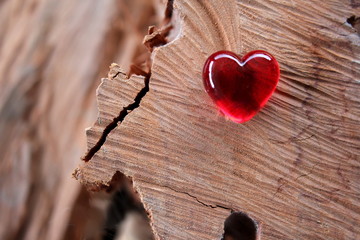 Red Glass Heart  with soft focus wood background