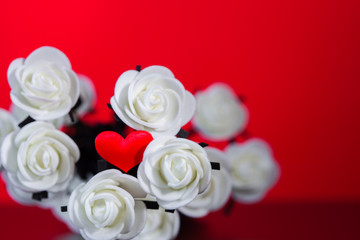 White flowers on red background for valentines with heart