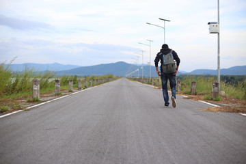 Man walking on road in Rayong, Thailand