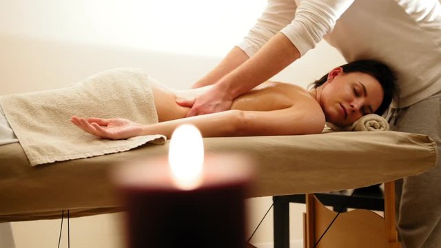 Beautiful young woman receiving massag at spa. Medicine therapy for caucasian model, slider