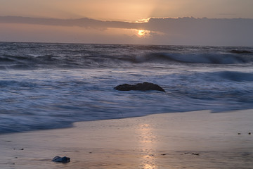 Fototapeta na wymiar Long Exposure of rocks and surf at El Matador State beach after sunset