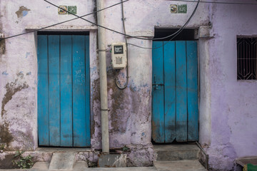 Two blue doors in a lilac painted building, Agra