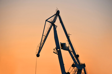 Port cargo crane at sunset