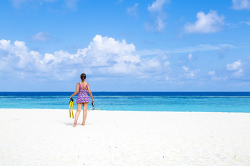 Fototapeta na wymiar Carefree young woman relaxing on tropical beach