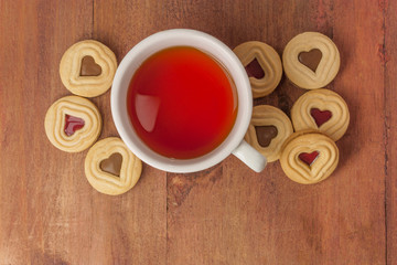 Tea cup and butter cookies with heart-shaped filling