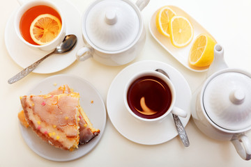 lemon cake with tea. Breakfast in bed. White background, white crockery
