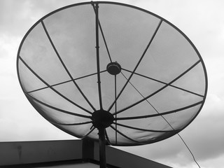 Satellite dishes on top of building , black and white tone