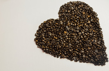 Heart made of Coffee Beans on White Background