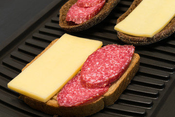 nice sandwich with sausage and cheese on toast background