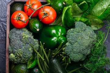 Food background of green vegetables broccoli romaine lettuce celery pepper zucchini on black table Healthy lifestyle Top view Copy space