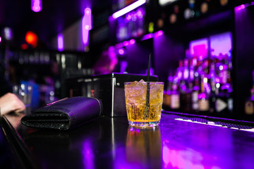 A cocktail is served at the bar