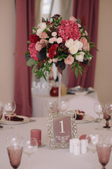 Wedding guest table decorated with bouquet and settings