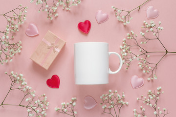 White coffee mug with little white flowers, gift box and hearts
