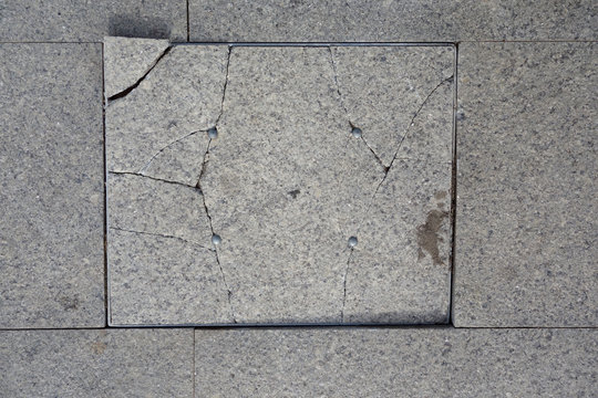 Broken tile on the pavement