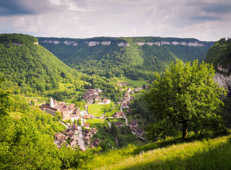 Village with church against green mountains