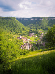 Village with church against green mountains