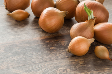 White onions on the wooden board in the kitchen. Healthy eating and lifestyle.