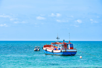 a small wooden fishing boat is floating in the blue sea colorful thailand asia transportation