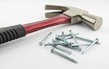 Nails with red iron hammer on a white background.