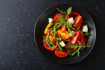 Fototapeta na wymiar Healthy salad on black plate