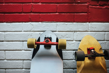 Two longboards at the brick wall