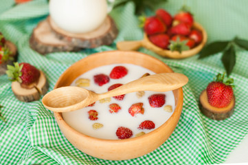 Obraz na płótnie Canvas spoon, milk and stawberries