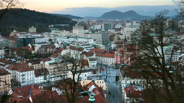 Aerial view of Ljubljana, Slovenia city center in the evening. Sunset over Triple bridge with mountains at the background