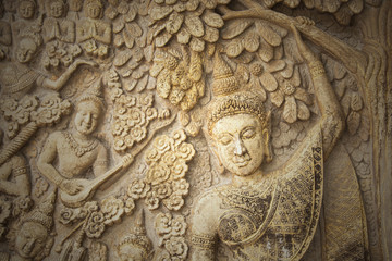 Fototapeta na wymiar Low-relief image of beautiful woman in the north of temple of Thailand, no copyright