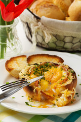 Baked sandwich with egg, cheese and ham.