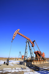 Fototapeta premium Oil field, oil pump in the work
