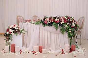 Fototapeta premium Wedding table decorated with bouquet and candles