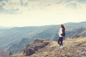 Naklejka na ściany i meble Woman hiker standing on top of the mountain
