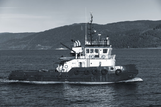 Tug boat with white superstructure