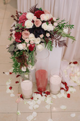 A little pedestal, decorated with bouquet and candles