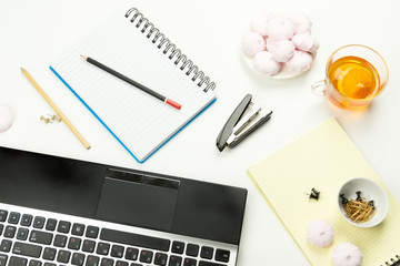 Pencils, a stapler, buttons, Notepad, laptop, marshmallows,  Cup