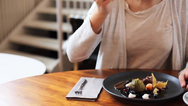woman eating ice cream dessert with coffee at cafe