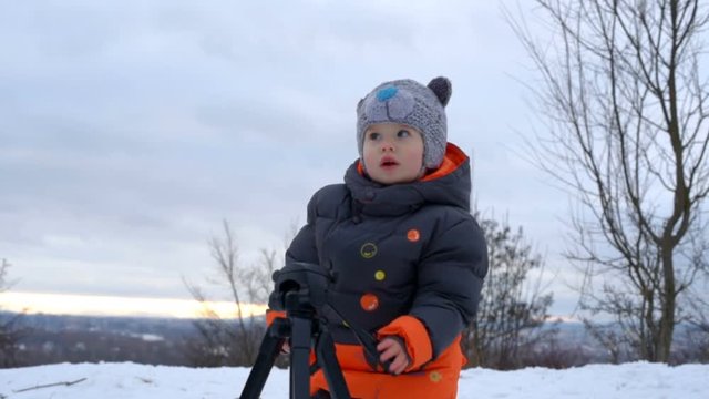 Cute kid playing with tripod