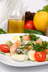 Catfish salad with mustard sauce with herbs on a white plate