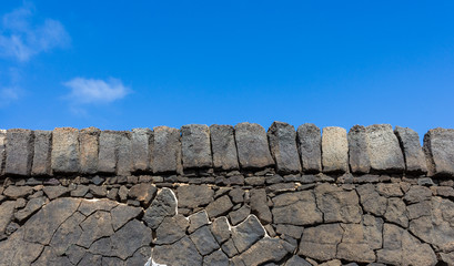 stone wall with blue sky background