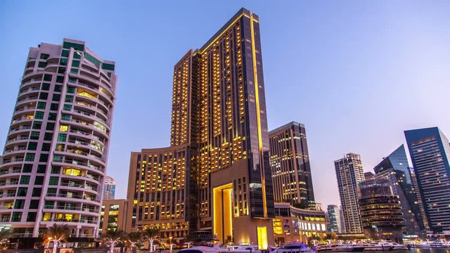 Dubai, UAE:  tower in the district of Dubai Marina. Transition day into night.