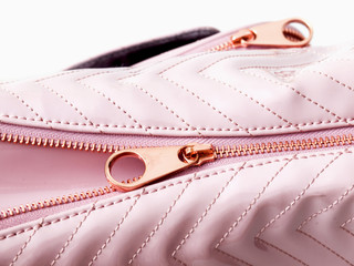 Luxury pink leather detail handbag with metal lock zipper closeup
