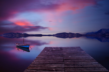 Beautiful environment with a lonely boat in a calm lake - 136155051