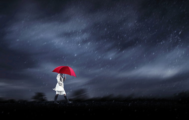 girl walking in a rainy day on heavy wind storm day