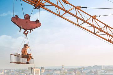 Man resting on construction on high and eating.