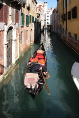 Fototapeta na wymiar Gondola on a canal in Venice, Italy