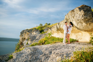 Naklejka na ściany i meble Couple wearing on dress with a pattern at beautiful landscape, o