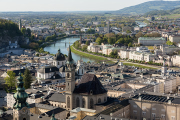 Fototapeta na wymiar Top view of the Salzach river and the old city in center of Salzburg, Austria, from the walls of the fortress / Festung Hohensalzburg /
