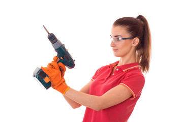 pretty brunette lady makes refurbish an apartment with drill in hands isolated on white background in studio